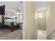 Hallway view into the bedroom featuring a large bed and ceiling fan at 2111 N 77Th Gln, Phoenix, AZ 85035