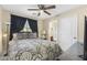Bedroom with a dark-toned bed and bedside table, with an ensuite bathroom at 2111 N 77Th Gln, Phoenix, AZ 85035