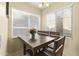 Charming breakfast nook with wooden table, seating, and bright natural light streaming in from the windows at 2111 N 77Th Gln, Phoenix, AZ 85035