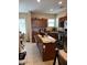 Well-lit kitchen featuring stainless steel appliances, tiled floors, a kitchen island, and wood cabinets at 2111 N 77Th Gln, Phoenix, AZ 85035