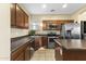 Contemporary kitchen with stainless steel appliances, an island, and dark wood cabinets for a sleek, modern look at 2111 N 77Th Gln, Phoenix, AZ 85035