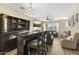 Elegant living room features a wet bar, fireplace, and comfortable seating, perfect for relaxation and entertaining guests at 2111 N 77Th Gln, Phoenix, AZ 85035