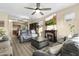 Open-concept living space featuring a fireplace, kitchen access, and comfortable seating for entertaining and relaxation at 2111 N 77Th Gln, Phoenix, AZ 85035