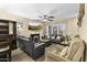Spacious living room with modern furniture, a fireplace, and built-in bar, perfect for relaxing and entertaining guests at 2111 N 77Th Gln, Phoenix, AZ 85035