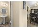 Cozy powder room featuring a pedestal sink, stylish fixtures, and a wooden floor at 2111 N 77Th Gln, Phoenix, AZ 85035