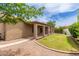 A large backyard with lush green grass, mature landscaping, and a covered patio at 2189 E Ranch Ct, Gilbert, AZ 85296