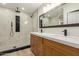 Modern bathroom with a double vanity, a rain shower head and decorative floor in the walk-in shower area at 2189 E Ranch Ct, Gilbert, AZ 85296