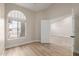 A sunlit bedroom featuring a large window with blinds and neutral wall color, offering a bright and airy space at 2189 E Ranch Ct, Gilbert, AZ 85296
