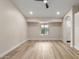 Spacious bedroom with wood floors, recessed lighting, and a view to a garden through a window at 2189 E Ranch Ct, Gilbert, AZ 85296