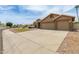 Lovely home with three-car garage, desert landscaping, and large driveway on a corner lot at 2189 E Ranch Ct, Gilbert, AZ 85296