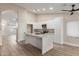 Modern kitchen featuring white cabinetry, marble countertops and island with seating at 2189 E Ranch Ct, Gilbert, AZ 85296