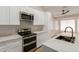 Bright kitchen with stainless steel appliances, marble countertops, and an island with a sink for convenience at 2189 E Ranch Ct, Gilbert, AZ 85296