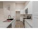Modern kitchen with white cabinets, marble countertops, and stainless steel appliances offering a sleek design at 2189 E Ranch Ct, Gilbert, AZ 85296