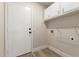 Spacious laundry room with overhead storage cabinets and direct access to the exterior at 2189 E Ranch Ct, Gilbert, AZ 85296