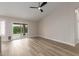 Light-filled living room with wood-look floors and sliding glass door to outdoor patio at 2189 E Ranch Ct, Gilbert, AZ 85296