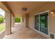 Enjoy a relaxing covered patio with stone flooring and lush landscaping at 2189 E Ranch Ct, Gilbert, AZ 85296