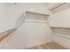 A walk-in closet with built in shelving and wooden closet rods, offering plenty of storage space at 2189 E Ranch Ct, Gilbert, AZ 85296