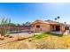 Backyard featuring a pool surrounded by decorative brickwork and bordered by a wrought iron fence at 22615 N 31St Dr, Phoenix, AZ 85027