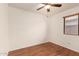 A bright bedroom features wood-look flooring, a ceiling fan, and a window with blinds at 22615 N 31St Dr, Phoenix, AZ 85027