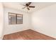 A bright bedroom features wood-look flooring, a ceiling fan, and a window with blinds at 22615 N 31St Dr, Phoenix, AZ 85027