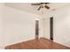 Bright bedroom features wood-look flooring, and closet with sliding doors and an open doorway to the hallway at 22615 N 31St Dr, Phoenix, AZ 85027