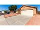 Exterior view of a single-story home featuring a two-car garage and front yard at 22615 N 31St Dr, Phoenix, AZ 85027