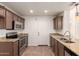 Beautiful kitchen featuring granite countertops, stainless appliances, and dark cabinetry at 22615 N 31St Dr, Phoenix, AZ 85027