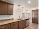 Open kitchen features granite countertops, stainless steel dishwasher and dark cabinetry at 22615 N 31St Dr, Phoenix, AZ 85027