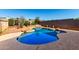 Sparkling backyard pool with rock waterfall feature and desert landscaping offers a private retreat at 22615 N 31St Dr, Phoenix, AZ 85027