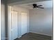 Bedroom featuring a ceiling fan and two closets with white doors at 2301 E University Dr # 334, Mesa, AZ 85213