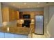 Well-lit kitchen with stainless steel appliances, tile backsplash, and countertops at 2301 E University Dr # 334, Mesa, AZ 85213