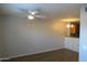 Bright living room with ceiling fan and updated flooring, open to the kitchen at 2301 E University Dr # 334, Mesa, AZ 85213