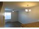 Open-concept living space with updated floors and an elegant chandelier at 2301 E University Dr # 334, Mesa, AZ 85213