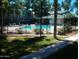Outdoor pool surrounded by a black iron fence and greenery at 2301 E University Dr # 334, Mesa, AZ 85213