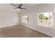 Bedroom featuring a ceiling fan, plush carpet, and windows offering natural light and views at 2339 W Ponderosa Ln, Phoenix, AZ 85023
