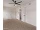 Spacious bedroom with ceiling fan, closet, and access to an attached bathroom with a toilet at 2339 W Ponderosa Ln, Phoenix, AZ 85023