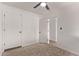 Carpeted bedroom with access to bathroom, and bright white walls, ceiling fan, and closet at 2339 W Ponderosa Ln, Phoenix, AZ 85023