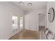 Bright bonus room boasts wood floors, french doors to the backyard, and a modern mirror at 2339 W Ponderosa Ln, Phoenix, AZ 85023