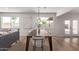 Dining area with hardwood floors, modern lighting, and large windows at 2339 W Ponderosa Ln, Phoenix, AZ 85023