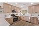 Modern kitchen with stainless steel appliances, light wood cabinets, and great natural light at 2339 W Ponderosa Ln, Phoenix, AZ 85023