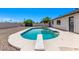 Inviting pool with diving board offers a refreshing oasis in a low-maintenance backyard with desert landscaping at 2339 W Ponderosa Ln, Phoenix, AZ 85023