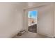 Bright, unfinished room features a doorway with a view to the backyard with brick and a blue sky at 2339 W Ponderosa Ln, Phoenix, AZ 85023