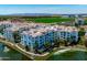 Aerial view of condo buildings and a pond, showcasing the community's layout and landscaping at 2511 W Queen Creek Rd # 116, Chandler, AZ 85248