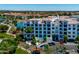 Exterior of a well-maintained condo building with manicured landscaping, a pond, and a parking lot at 2511 W Queen Creek Rd # 116, Chandler, AZ 85248
