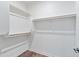 Bright walk-in closet with white walls and wood-look floors at 2511 W Queen Creek Rd # 116, Chandler, AZ 85248
