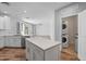 Spacious kitchen with island, stainless steel appliances, and an open view to the living room at 2511 W Queen Creek Rd # 116, Chandler, AZ 85248