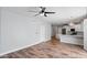 Open-concept living area showcasing the hard wood flooring and fan with light at 2511 W Queen Creek Rd # 116, Chandler, AZ 85248