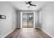 Well-lit main bedroom with wood floors and balcony access at 2511 W Queen Creek Rd # 116, Chandler, AZ 85248