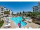 Resort-style pool with lounge chairs and tables, surrounded by lush landscaping and multi-story buildings at 2511 W Queen Creek Rd # 116, Chandler, AZ 85248