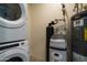 Utility room with washer, dryer, water heater, and water softener system at 2511 W Queen Creek Rd # 116, Chandler, AZ 85248